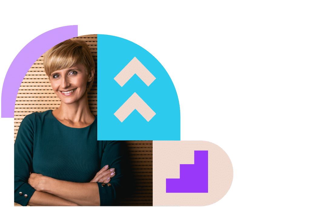 Smiling professional woman leans against a wall.