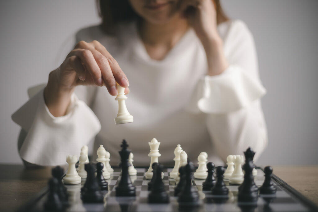businesswoman plays with chess game concept - A strategy gives your content purpose and enables you to connect with your audience in a way that supports your goals.