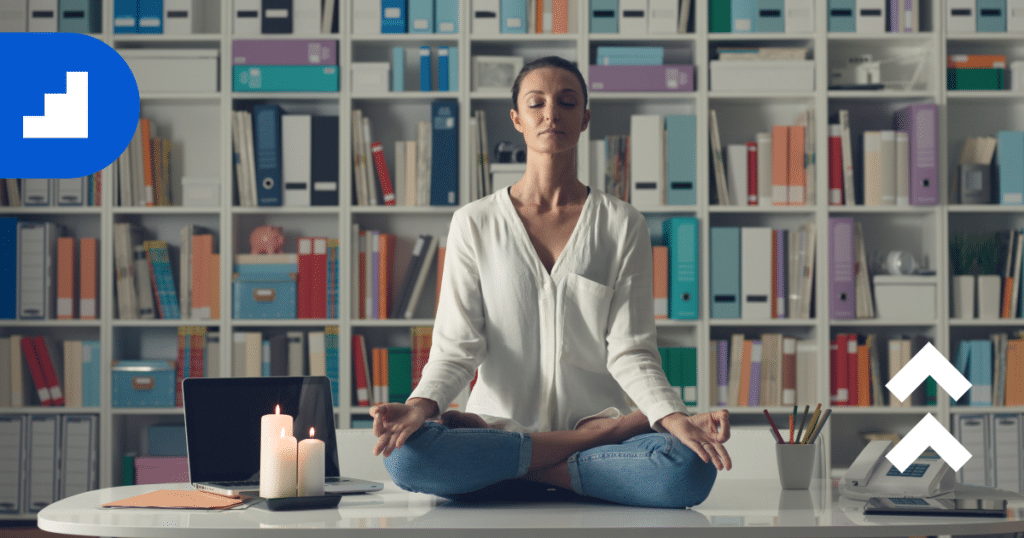 meditation for work life balance  - woman sitting on desk meditating