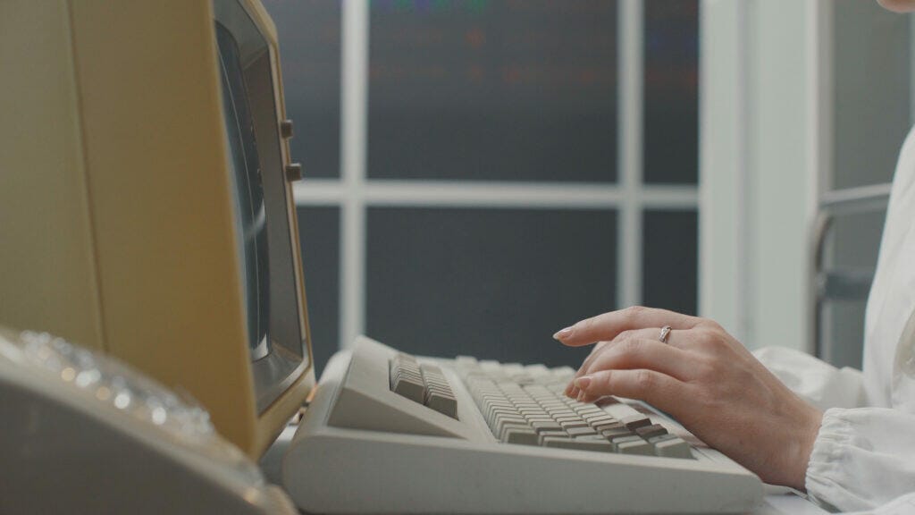 woman working with an old computer - women in tech during World War II