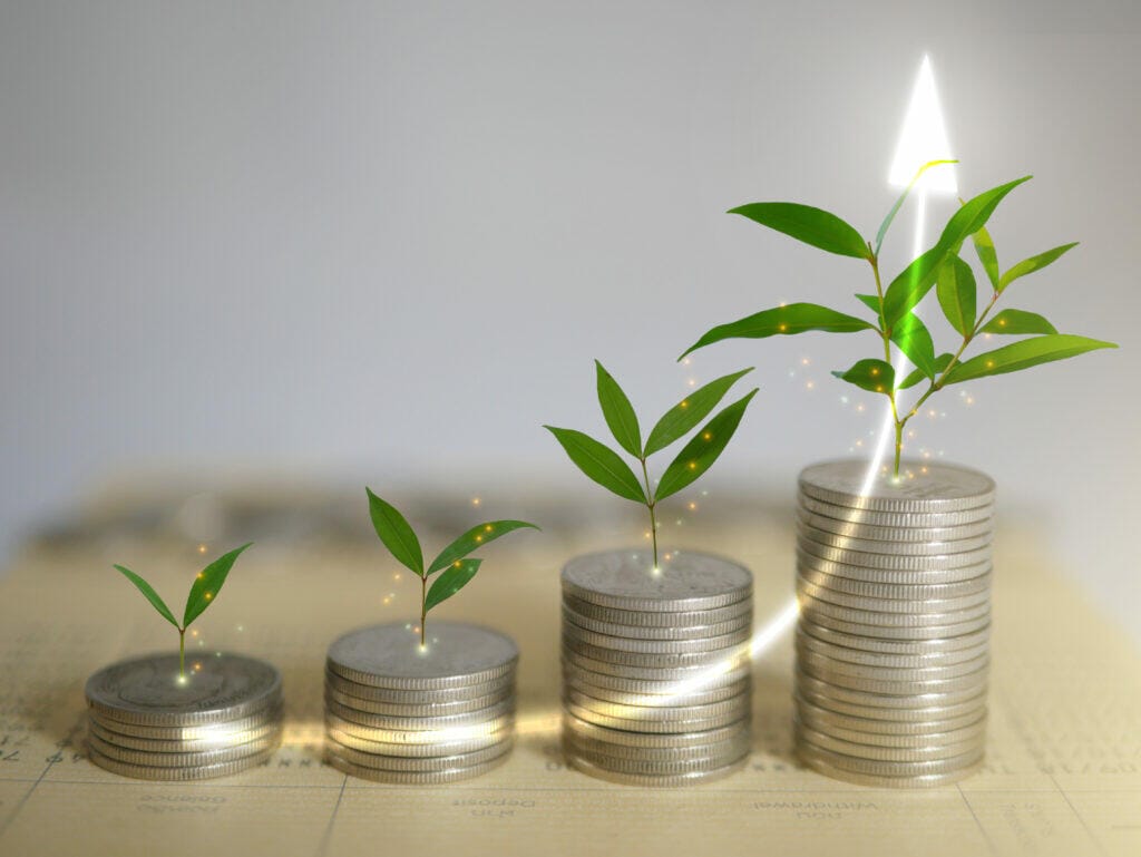 stacks of coins money with plants on top: Taking climate action isn't just about being environmentally responsible—it can also lead to significant financial benefits for your business.