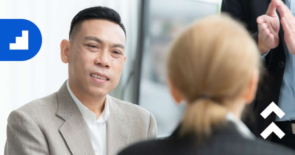 Business consultant listening attentively during a meeting, representing the value of outside perspectives for scaling businesses.