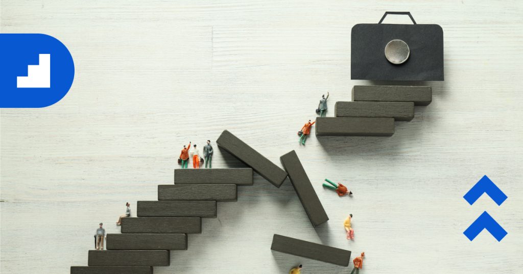 Small figurines ascending staggered wooden blocks arranged like steps, symbolizing progress, obstacles, and business growth.