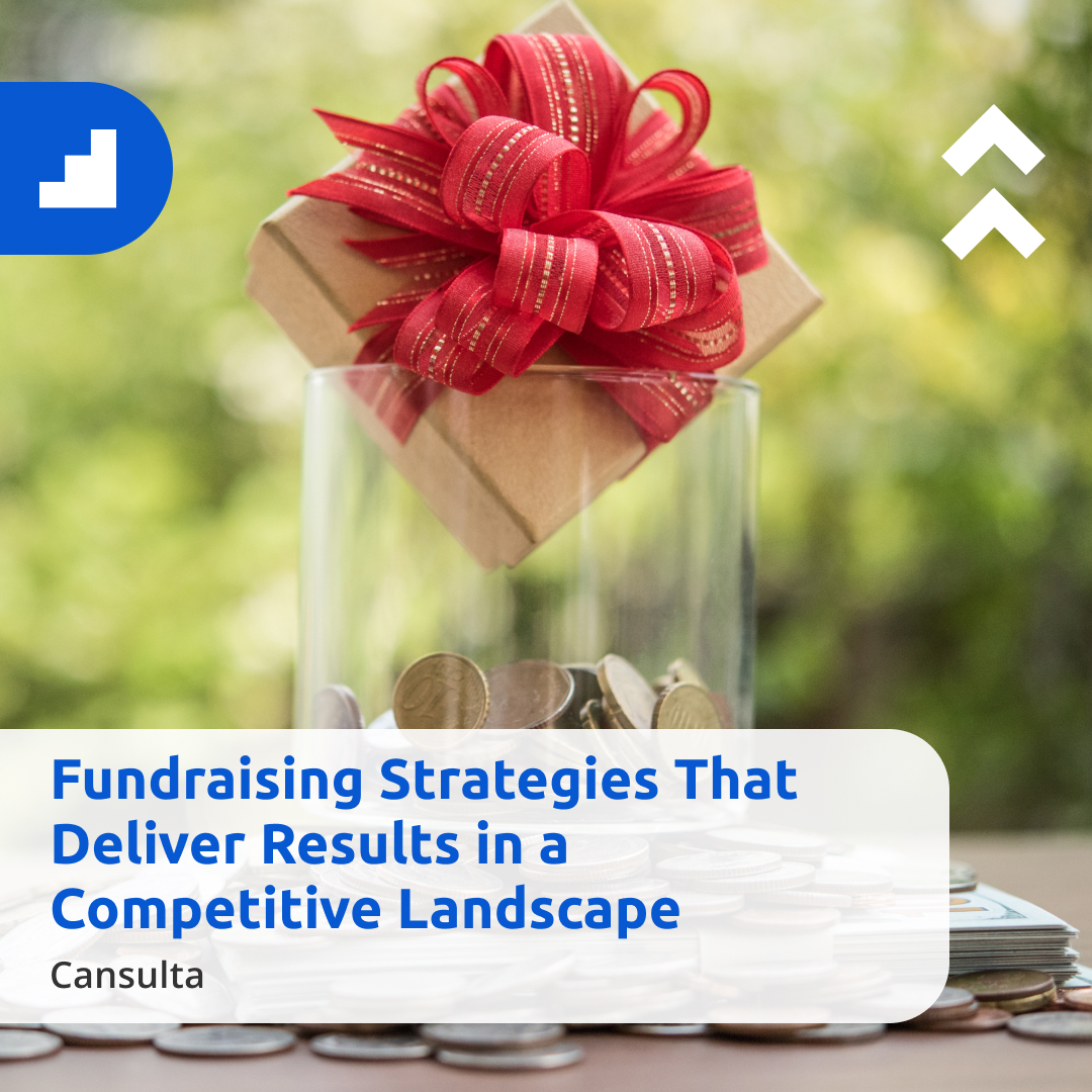 A glass jar filled with coins topped with a gift box tied with a red ribbon, set against a blurred green outdoor background. Overlaid text reads “Fundraising Strategies That Deliver Results in a Competitive Landscape,” with the name “Cansulta” shown below, representing effective and impactful fundraising efforts.