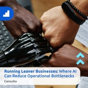 Three human fists and one robotic fist unite over a desk with documents, symbolizing how AI supports leaner businesses by streamlining teamwork. Text overlay highlights AI’s role in reducing operational bottlenecks in business operations.