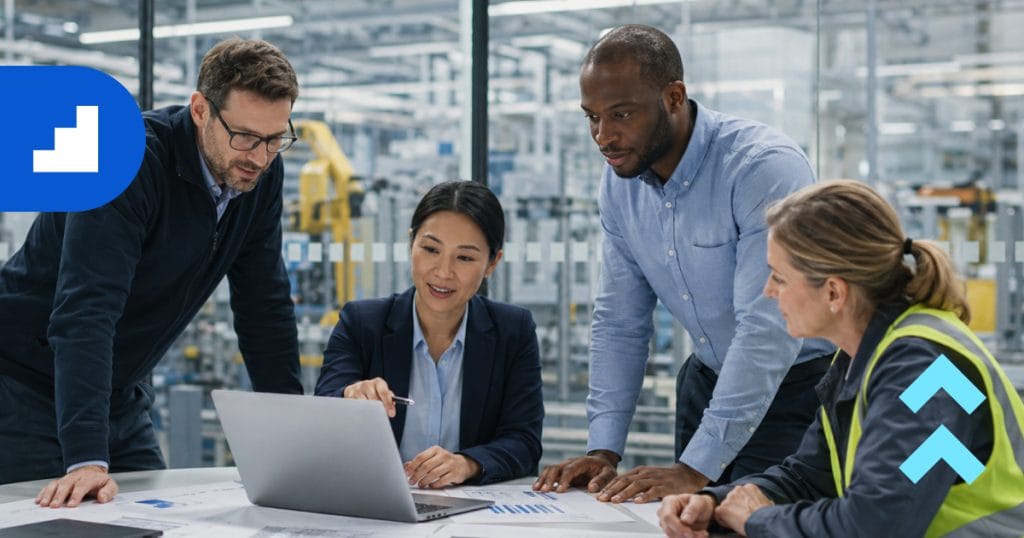 Manufacturing team reviewing AI for plant operations and production data on a factory floor.