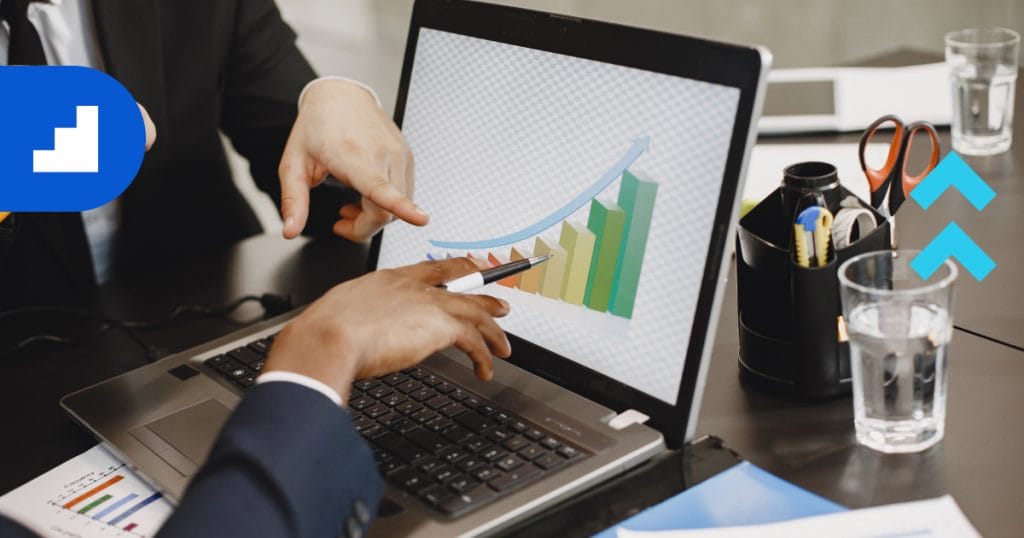 Marketing consulting experts are analyzing a business growth chart on a laptop to increase company revenue.