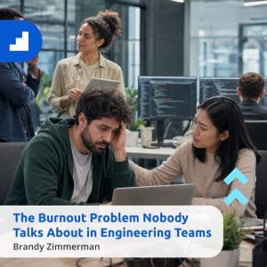 A software engineer experiencing workplace burnout in a modern tech office, being supported by a colleague. This image illustrates the mental health challenges in engineering teams. Title says "The Burnout Problem Nobody Talks About in Engineering Teams" with Cansulta Branding